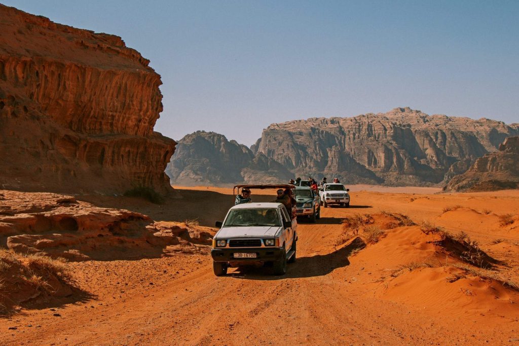 day tour, wadi rum, jordan, via jordan travel, wadi rum visitor center, seven pillars of wisdom, lawrence springs, al khazali canyon, tour company, tourist attractions, desert adventure, middle east, outdoor exploration, travel agency, natural beauty, sandstone formations, guided tour, desert landscape, unique experience, historical sites, red sand dunes, jeep tour, camping, rock climbing, bedouin culture, adventure travel, hiking trails, desert safari, arid wilderness, dune bashing, group tours, off-road experience, cinematic location, photography opportunities, historical landmarks, cultural exploration, jordanian tourism, breathtaking views, camel rides, overnight stay, stargazing, rock arches, wildlife spotting, extreme sports, archaeological sites, sunset views, sunrise experience, travel packages, private tours, nature enthusiasts, geology exploration, sandstone cliffs, film location, middle eastern culture, rock formations, valley of the moon, jordanian adventure, magical experience, desert camp.